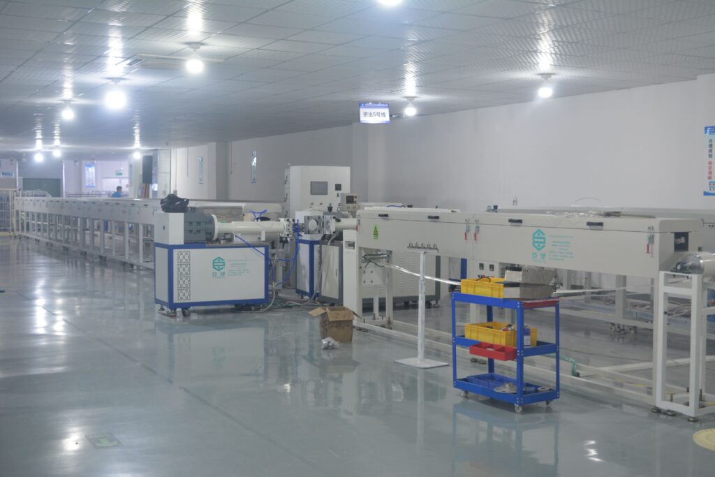 A clean, organized workshop in India with a complete silicone extrusion production line installed.