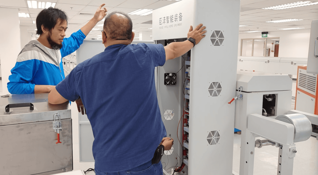 Our engineer explaining the electrical control box wiring and functions to the customer's maintenance team.