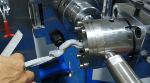 Defective silicone LED strip seal extruding unevenly from crosshead extrusion die.