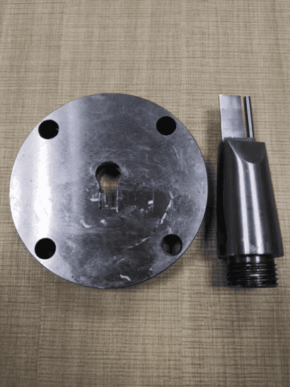 The central flow channel component (middle part) and core pin of the extrusion mold, cleaned and ready.