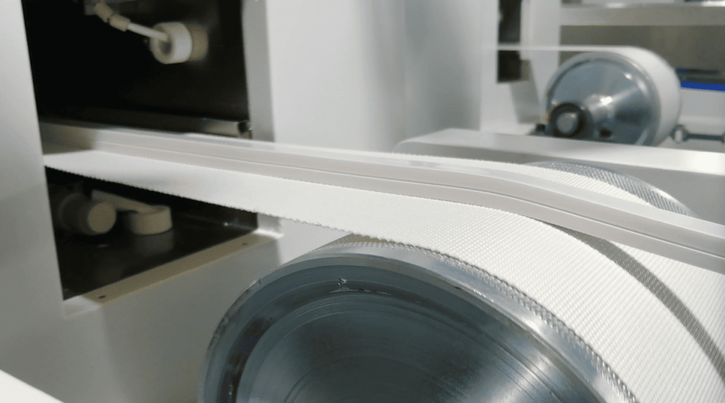 A flawless extruded silicone rubber LED strip moving steadily on the conveyor after perfect molding.