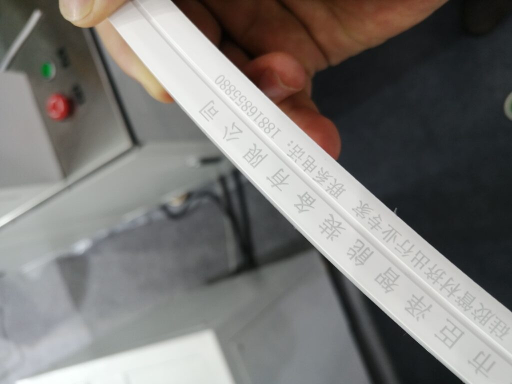 A section of silicone neon light strip laser-etched with our Chinese brand's logo.