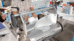 Operator refining and mixing raw silicone rubber compound in the material preparation area.