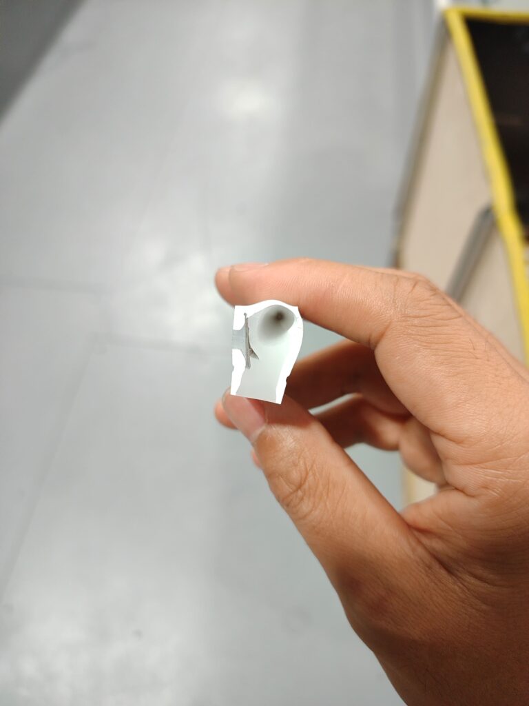 Cross-section view of a cut silicone LED strip sample containing trapped air bubbles.