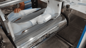 Operator adding pre-weighed diffuser agent into the silicone rubber compound during the refining process.