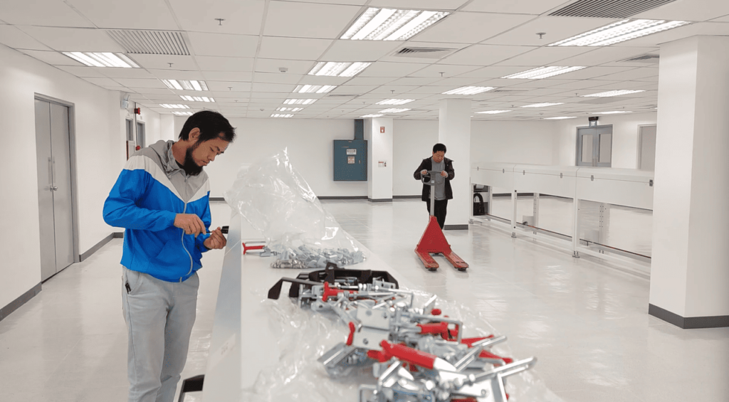 Technicians performing final assembly and integration of the complete silicone rubber LED strip extrusion production line.