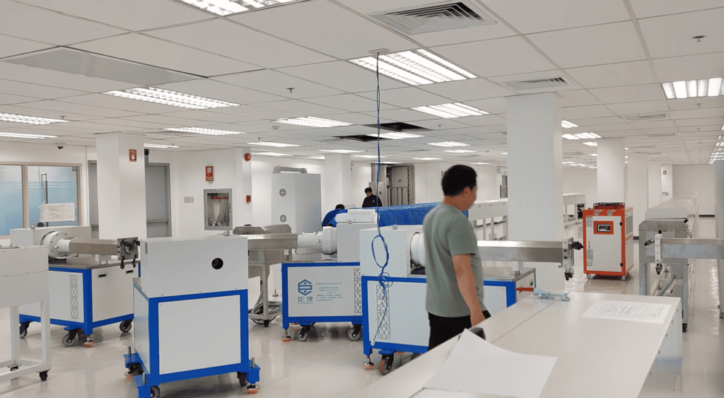 Newly arrived silicone rubber LED strip extrusion machines unpacked in customer's workshop before installation.