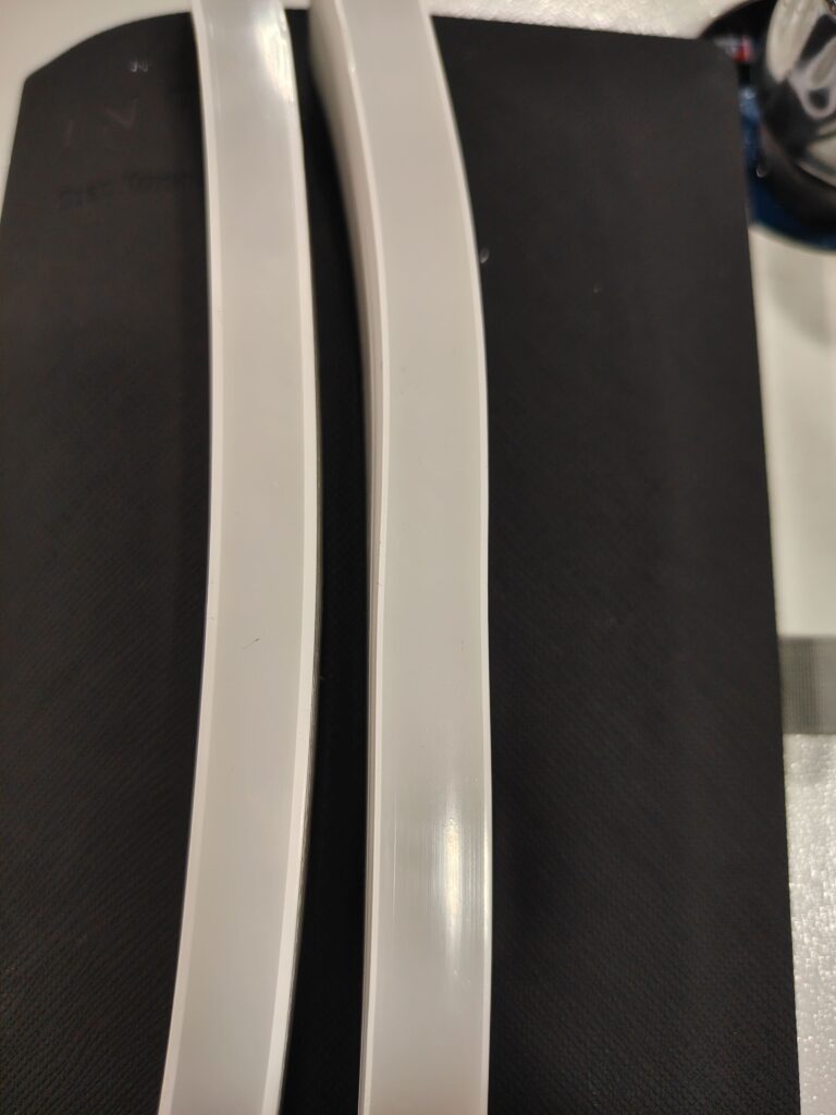 Two LED strip samples showing inconsistent and uneven opaque sidewall thickness on each strip and between them.
