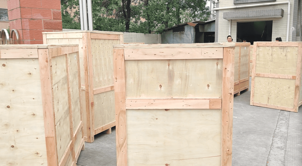 Silicone LED strip extrusion machine securely packaged in plywood crate for export shipping.