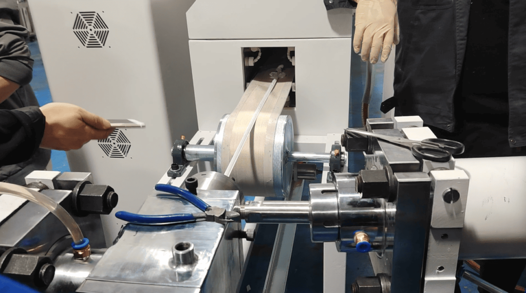 Technician adhering the leading end of a silicone rubber strip to the conveyor for initial tracking tension.