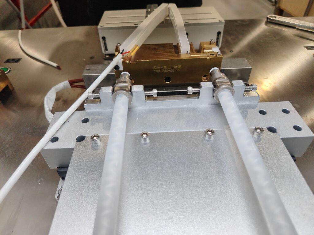 Cut LED strip segments placed in the end cap molding machine, ready for LSR injection.