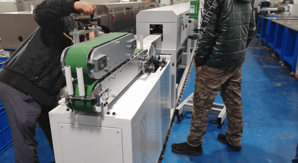 Technician adjusting the tracking or pulling machine tension for the extruded silicone rubber LED strip.