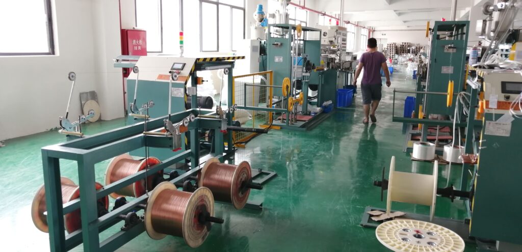 Alt Text: Two parallel PVC extrusion production lines for LED strips operating in a factory workshop.