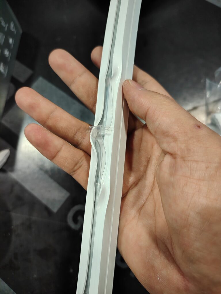 An extruded silicone LED strip exhibiting uneven bottom surface and material distribution defects