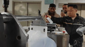 Technician using a precision digital scale to weigh diffuser agent for silicone rubber compounding