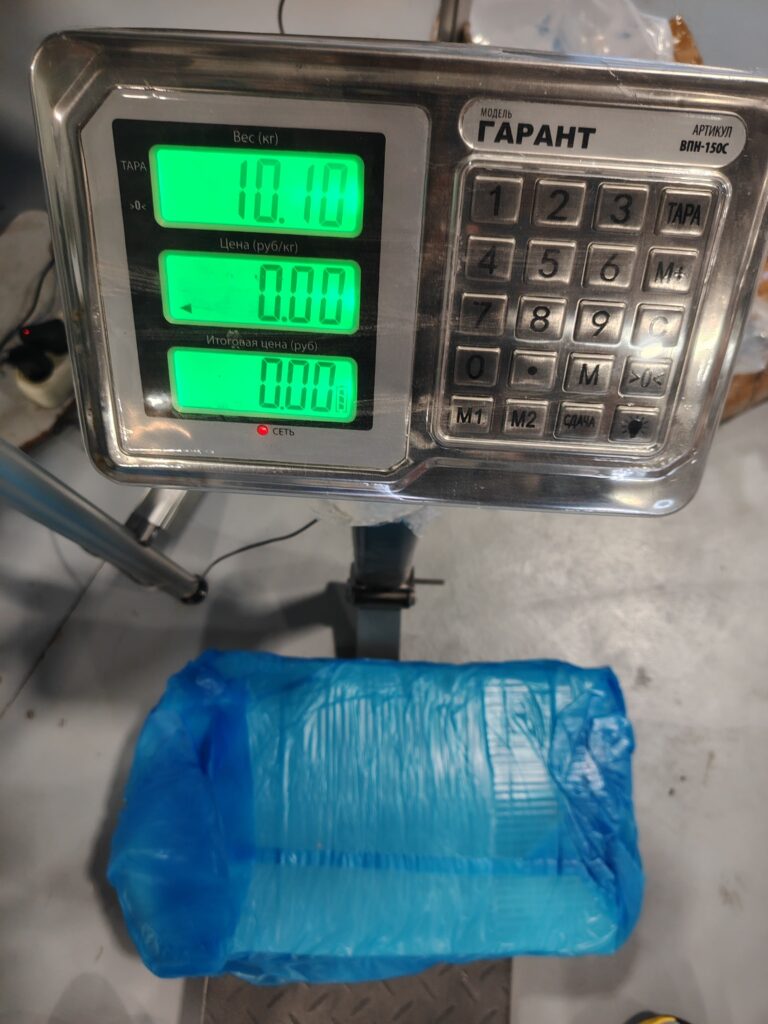 Technician weighing a batch of raw silicone rubber compound for production