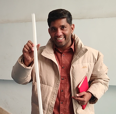 a happy customer hold the first meter of silicon LED strip he just made in the factory